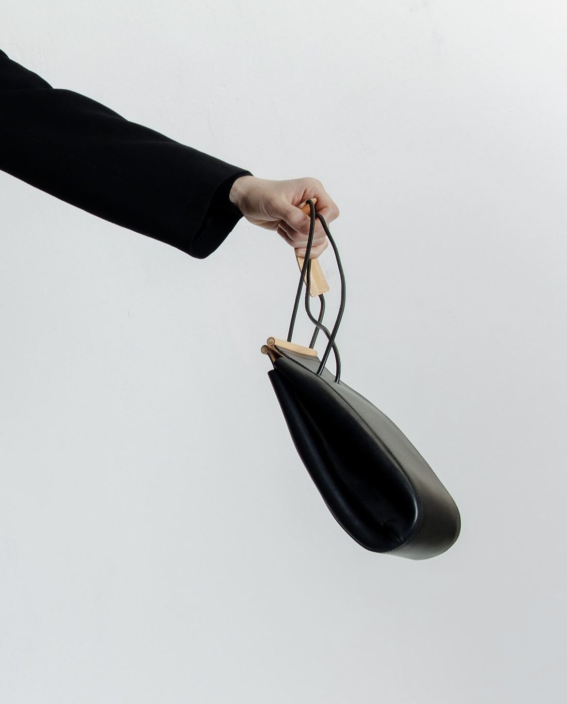 nowhow studios berlin 2023 6 a hand carrying nowhow studio handbag.