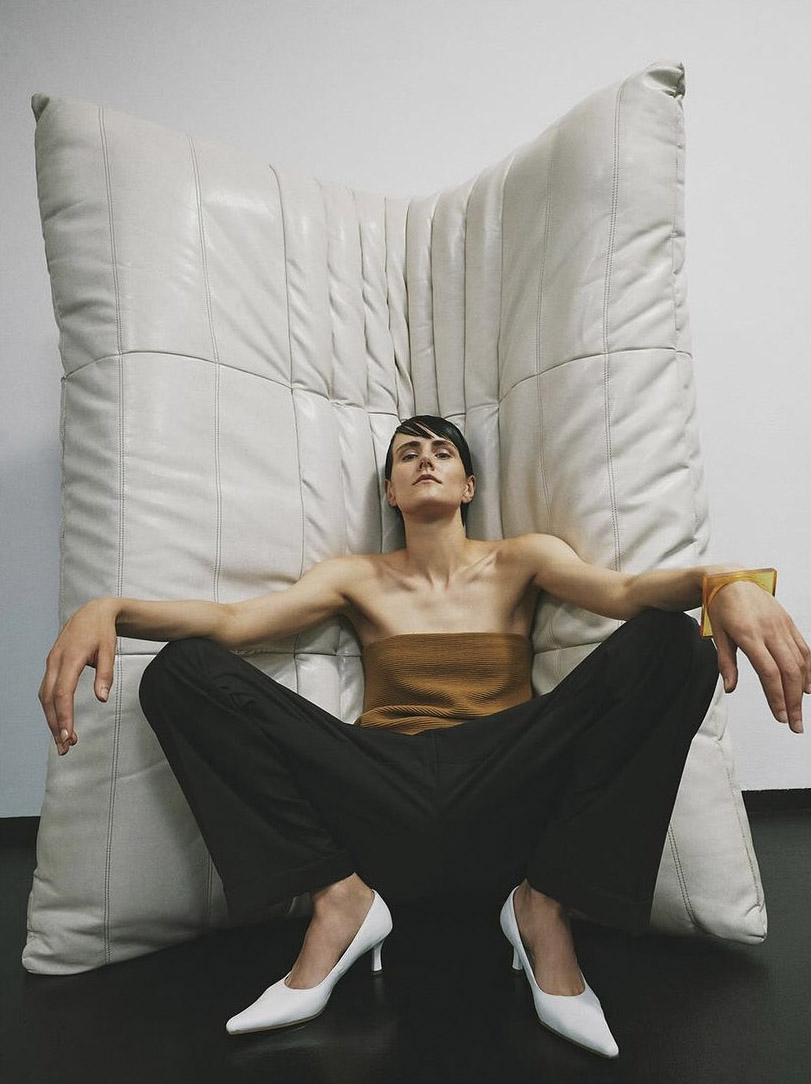 A female model posing with Togo Sofa