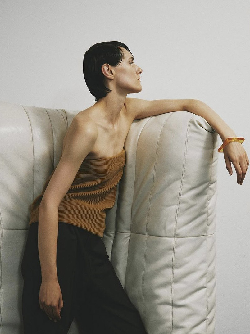 A female model posing with Togo Sofa