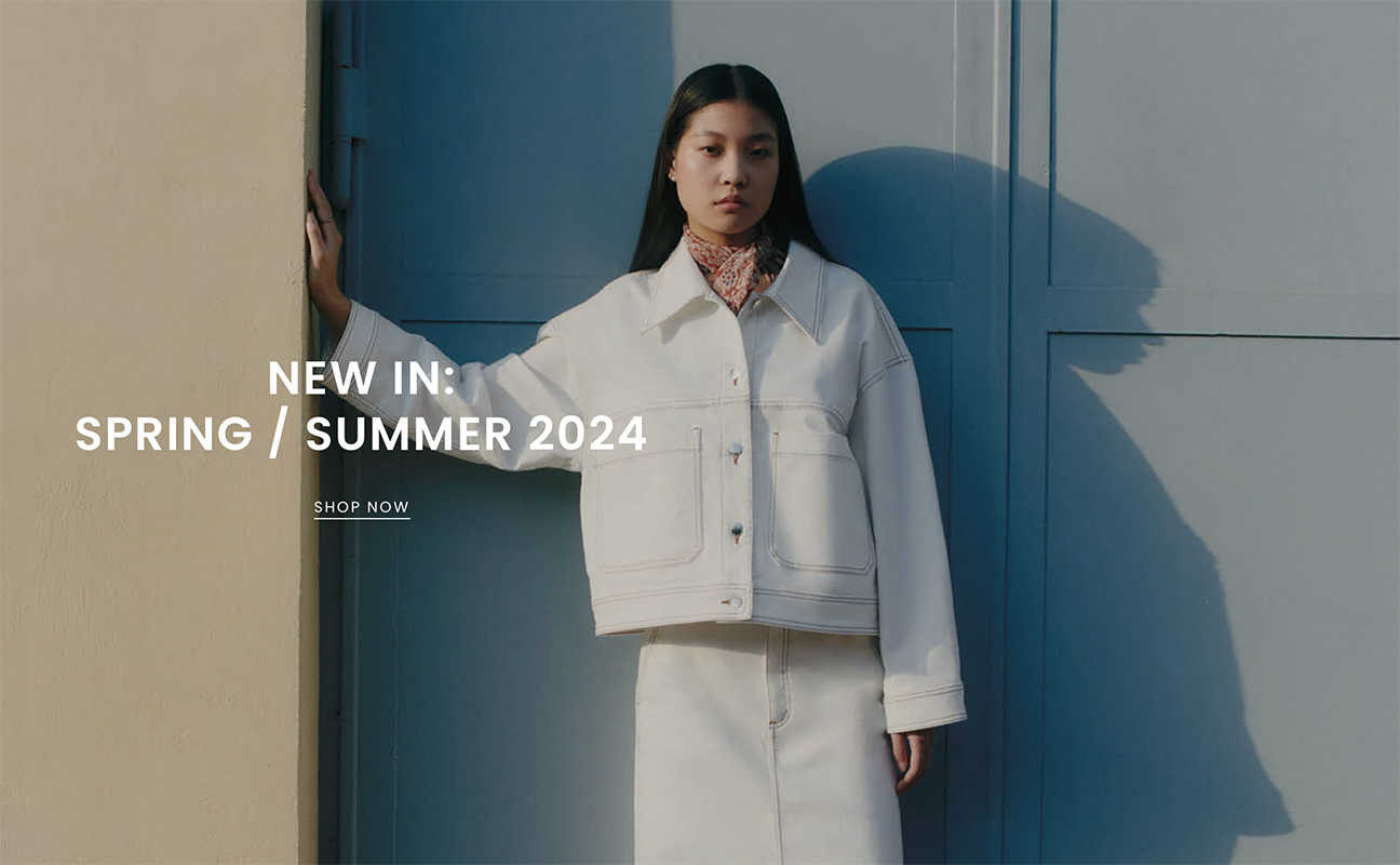 An Asian woman striking a pose outside of raw studios. for their SS24 campaign