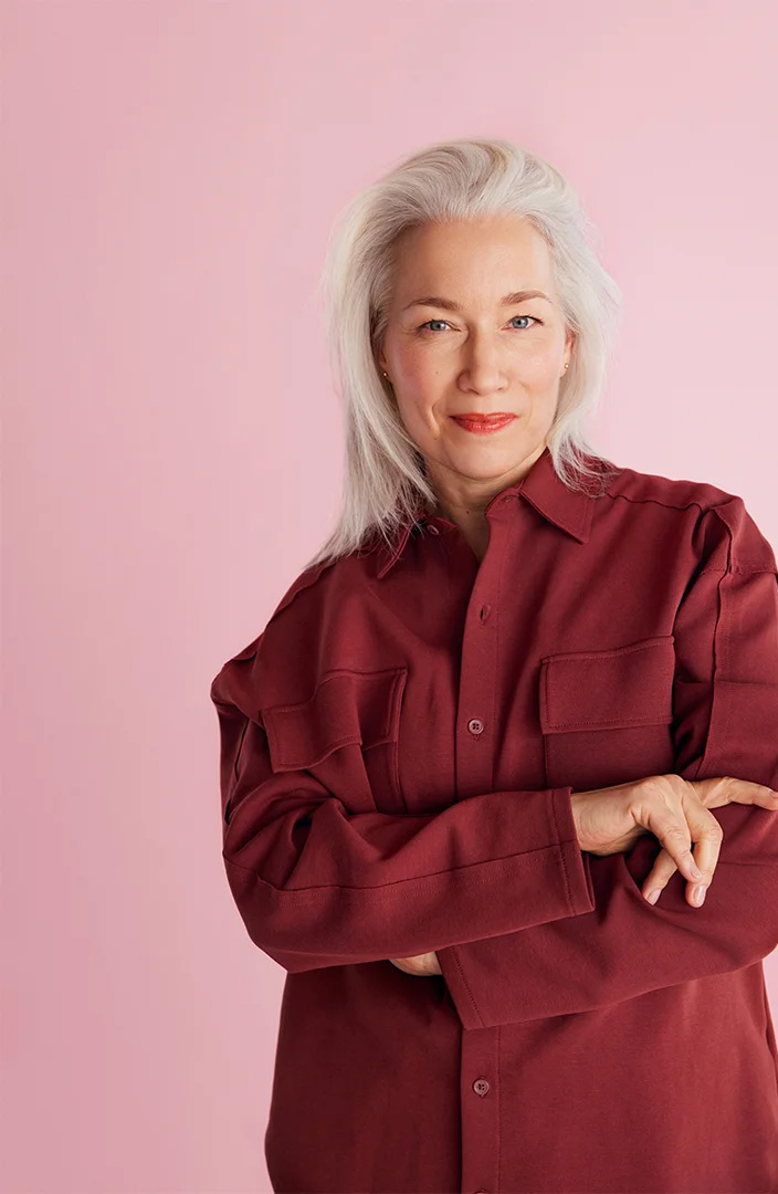 An elderly woman strikes a pose