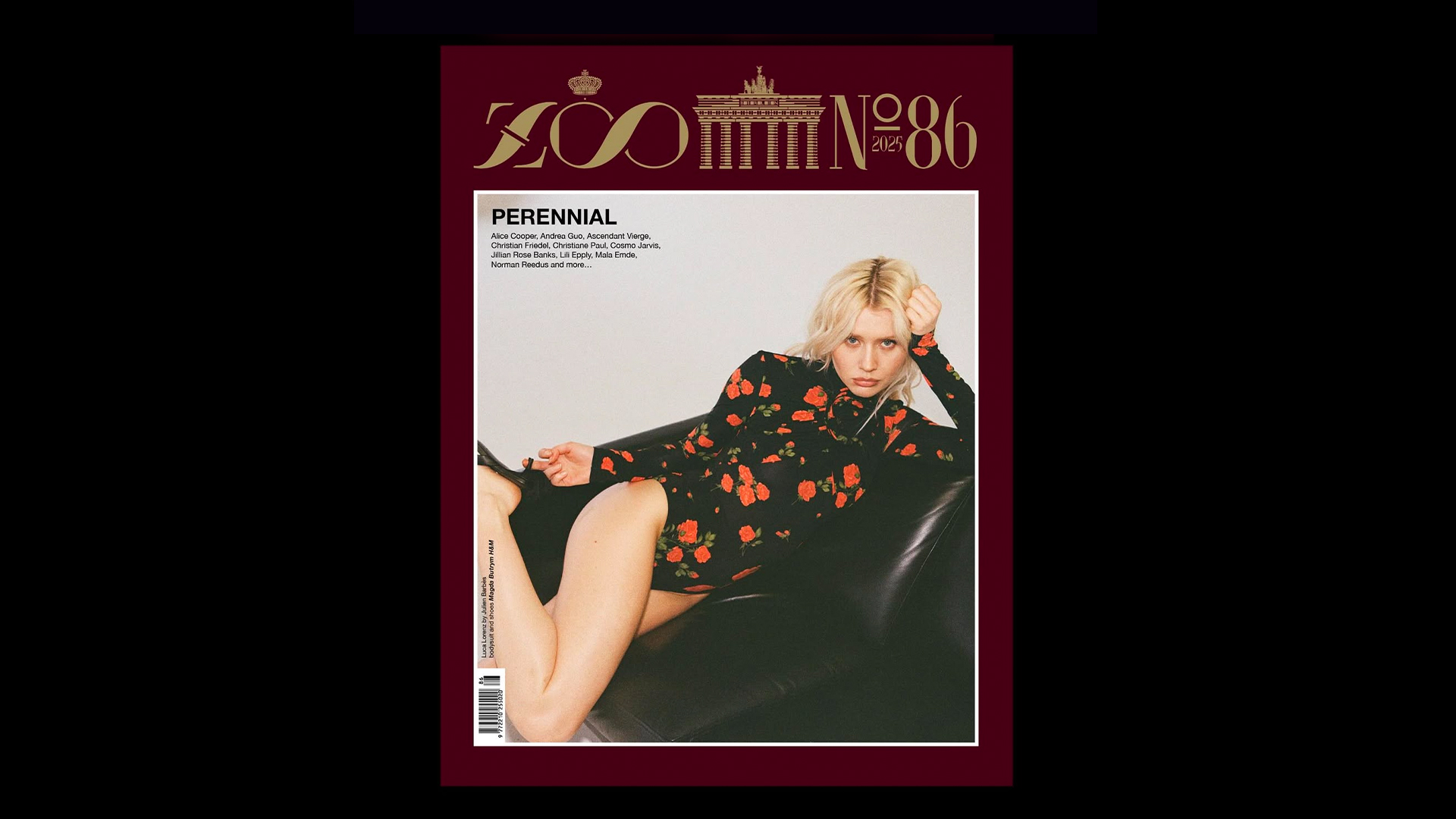 Cover of ZOO Magazine Issue 86, featuring model Luca Lorenz lounging on a black leather chair, wearing a black mini dress with bold red floral print from the Magda Butrym x H&M collection.