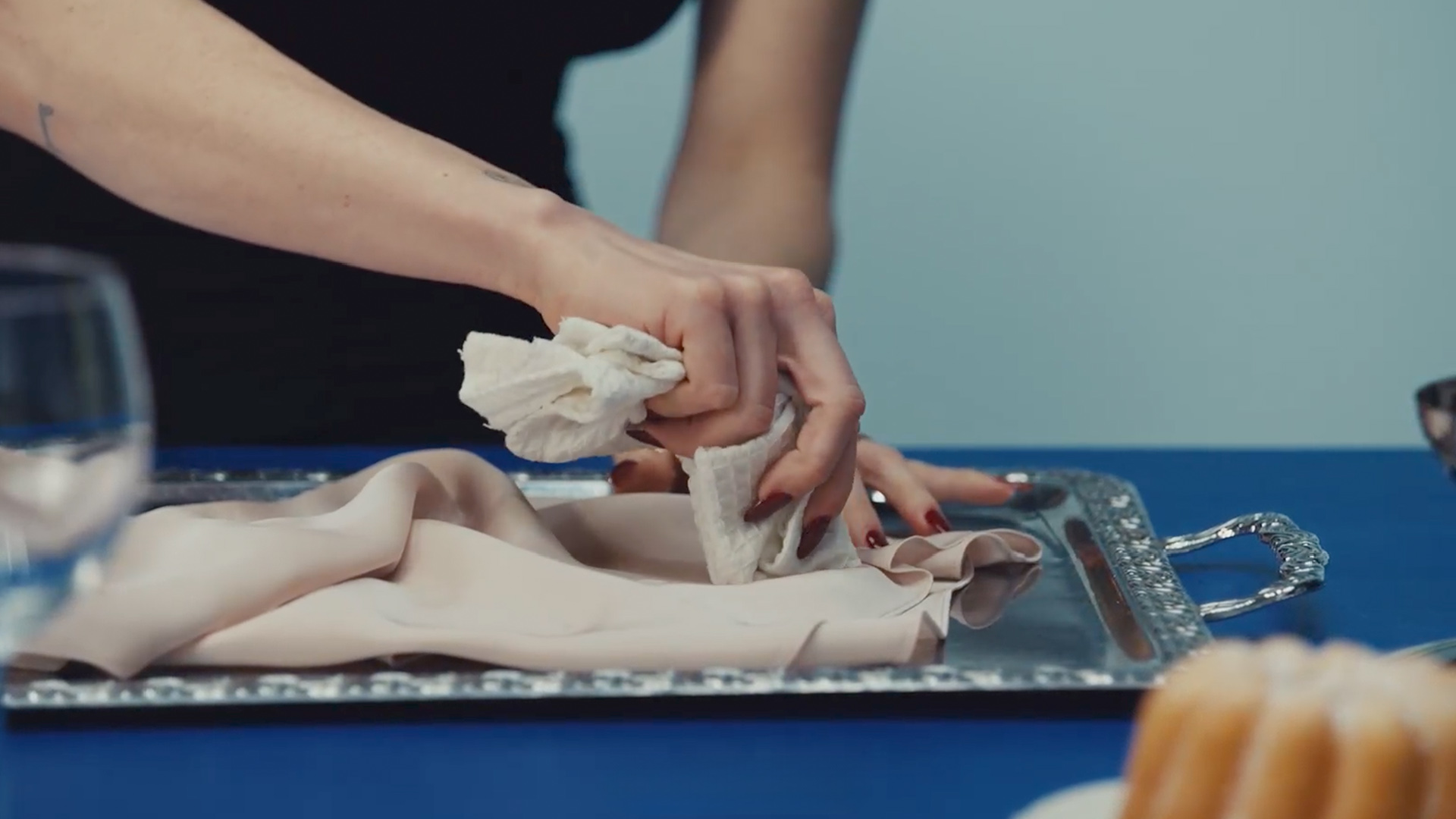 Detailed shot of stain removal on light fabric in Zalando Closet Care Episode 4, filmed at raw studios. Berlin photo studio for practical wardrobe care tips.